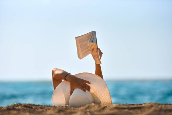A woman reads on the beach